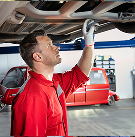 Mechanic conducting a full service inspection on a car for a thorough Warrant of Fitness check