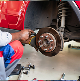 Mechanic conducting a full service inspection on a car for a thorough Warrant of Fitness check